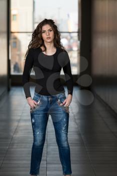 Fashion Model Wearing Jeans And Black Long Sleeve