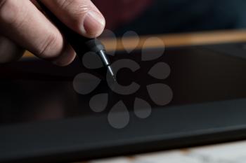 Closeup Of One Hand Drawing On A Computer Graphics Tablet