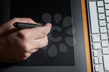 Closeup Of One Hand Drawing On A Computer Graphics Tablet