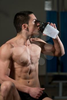 Young Muscular Man Drinking A Water Bottle