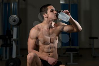 Young Muscular Man Drinking A Water Bottle