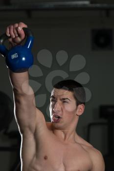 Muscular Man Exercise with Kettle Bell