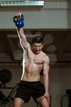 Muscular Man Exercise with Kettle Bell
