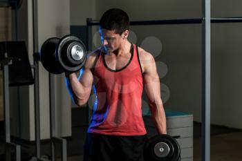 Young Man Exercise With Dumbbells