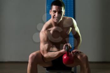 Young Man Exercise With Kettle Bell Biceps