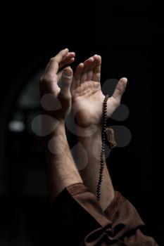 Hands Holding A Muslim Rosary In Mosque