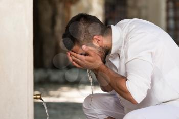 Muslim Man Preparing To Take Ablution In Mosque