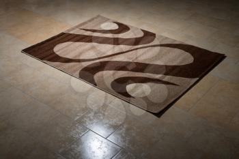 Single Brown Carpet Folded On Floor