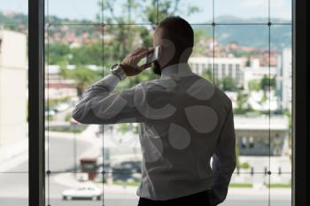 Businessman Talking On Telephone In Office