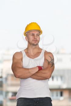 Portrait Of Handsome Engineer With Yellow Helmet