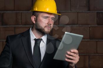Portrait Of Construction Master With Personal Computer In Hands