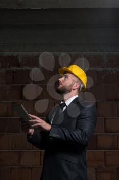 Portrait Of Construction Master With Personal Computer In Hands
