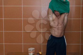 Muscular Young Male Athlete In Gym Dressing Room