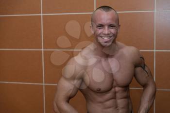 Muscular Young Male Athlete In Gym Dressing Room