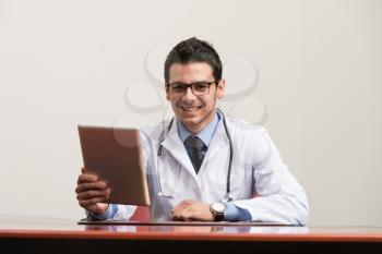 Handsome Doctor Looking At His Computer Monitor In His Office