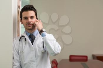 Young Doctor Talking On The Phone