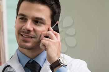 Young Doctor Talking On The Phone