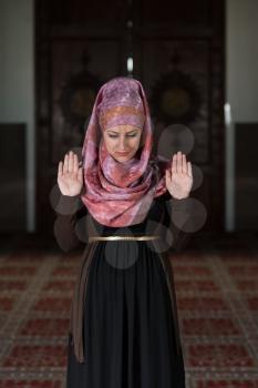 Young Muslim Woman Praying In Mosque