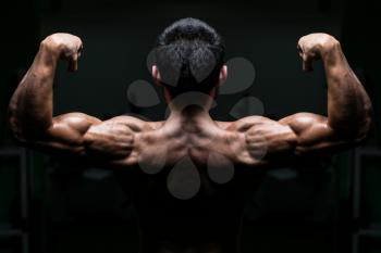 Young Male Athlete Flexing Back Muscles