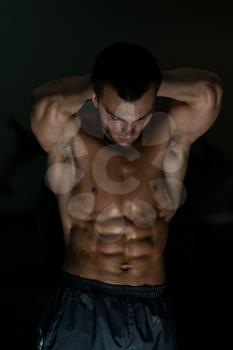 Young Muscular Men Flexing Abdominal Muscles