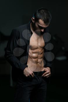 Young Attractive Male Model Standing In Unbuttoned Shirt