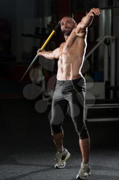 Mature Man Athlete Practicing To Throw A Javelin