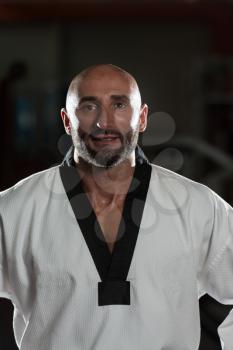 Portrait Of A Physically Fit Mature Man In Kimono With Black Belt
