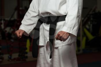 Man In A White Kimono And Belt For Martial Arts