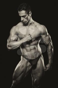 Young Bodybuilder Flexing Muscles - Isolate On Black Blackground - Copy Space