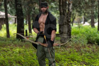 Beard Man With A Bow And Arrows In The Woods