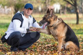 Man Holding Dog German Shepherd