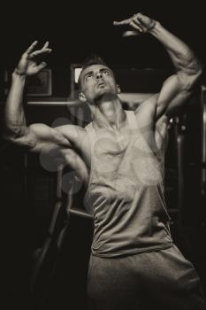 Portrait Of A Physically Fit Young Man - Flexing Muscles