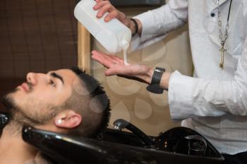 Hairstylist Hairdresser Washing Customer Hair - Young Man Relaxing In Hairdressing Beauty Salon