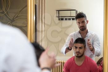 Hairdresser Preparing Young Man After A New Haircut
