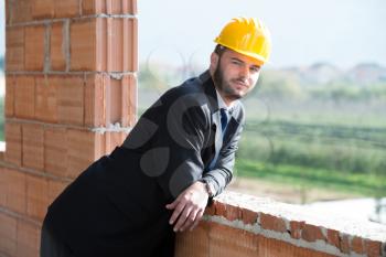 Portrait Of Business Man With Yellow Helmet On Construction
