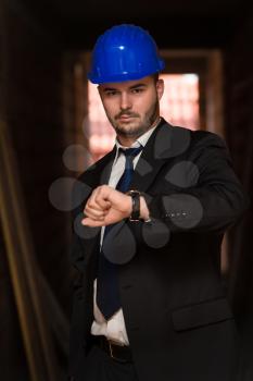 Businessman Looking At The Time On His Wrist Watch 