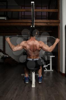 Bodybuilder Doing Heavy Weight Exercise For Back
