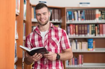 A Portrait Of An Caucasian College Student Man In Library - Shallow Depth Of Field