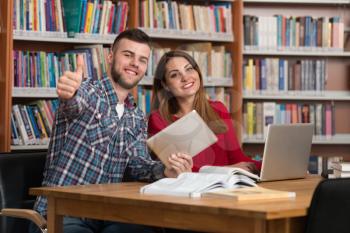 Portrait Of A Young Students Showing Thumbs Up In College Library - Shallow Depth Of Field