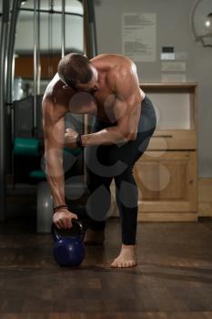 Athletic Man Workout With Kettle Bell