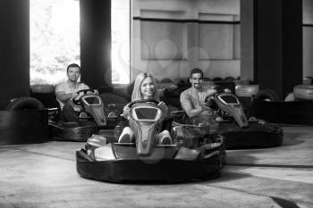 Group Of People Is Driving Go-Kart Car With Speed In A Playground Racing Track - Go Kart Is A Popular Leisure Motor Sports