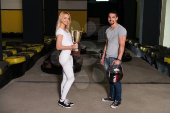 Young Woman Gives Man A Cup Speed Karting Race