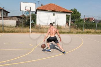 Basketball Player Bodybuilder Practicing And Posing For Basketball And Sports Athlete Concept