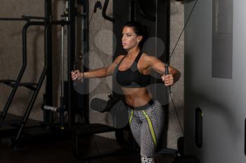 Young Woman Is Working On Her Chest With Cable Crossover In A Modern Gym