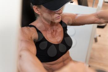 Middle Aged Woman Doing Heavy Weight Exercise For Chest