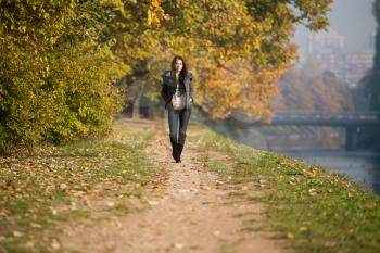 Young Woman Walking In Forest Through The Woods Outside During Autumn