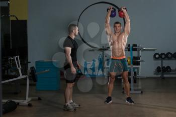 Handsome Guy Working Out Kettle Bell With Personal Trainer