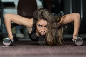 Young Adult Athlete Doing Push Ups With Dumbbells As Part Of Bodybuilding Training