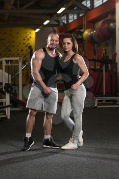 Portrait Of A Sexy Couple In The Gym With Exercise Equipment