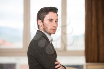 Portrait Of A Confident Young Male Teacher With Arms Crossed